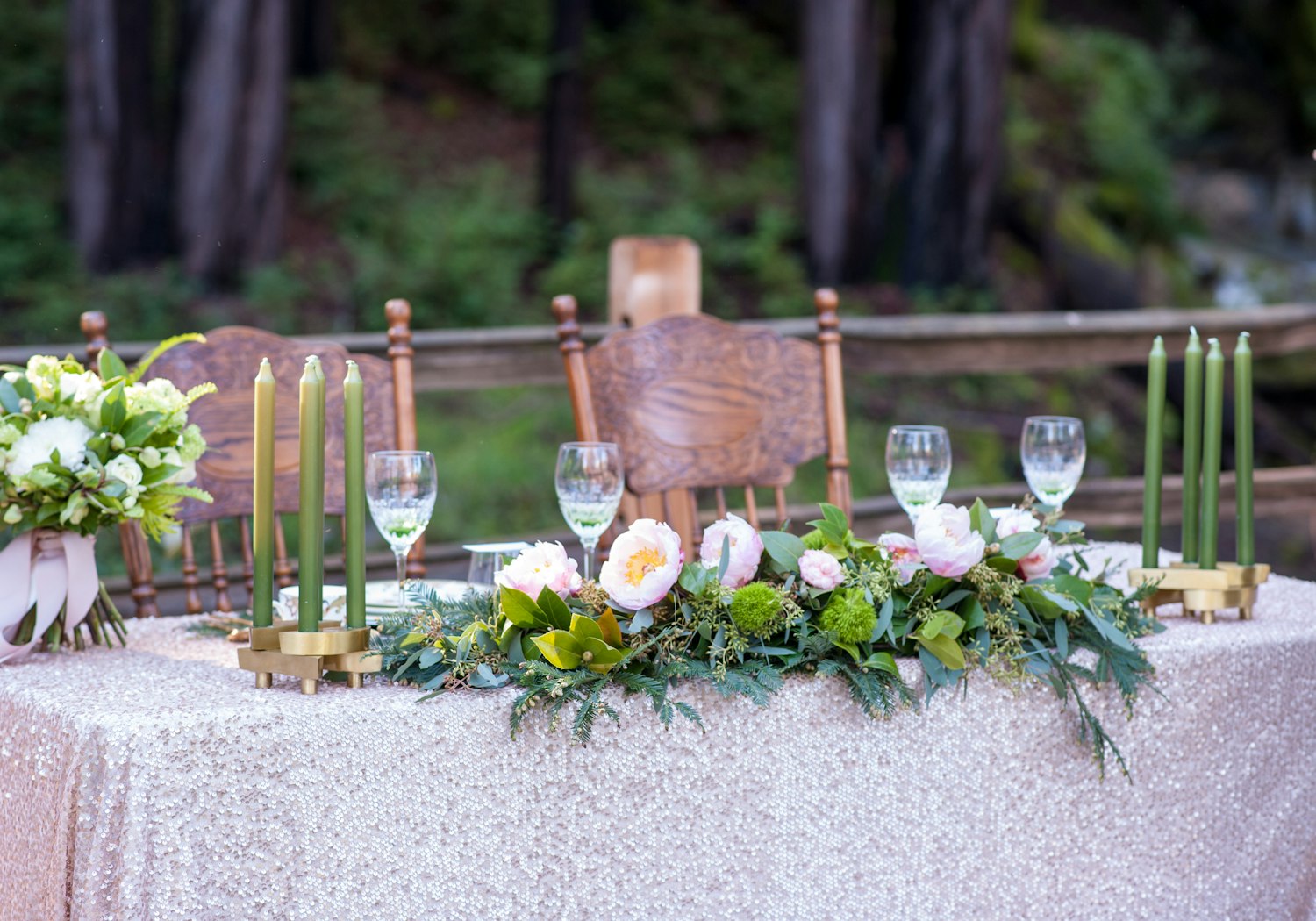 A long reception table styled with blooms and candlelight
