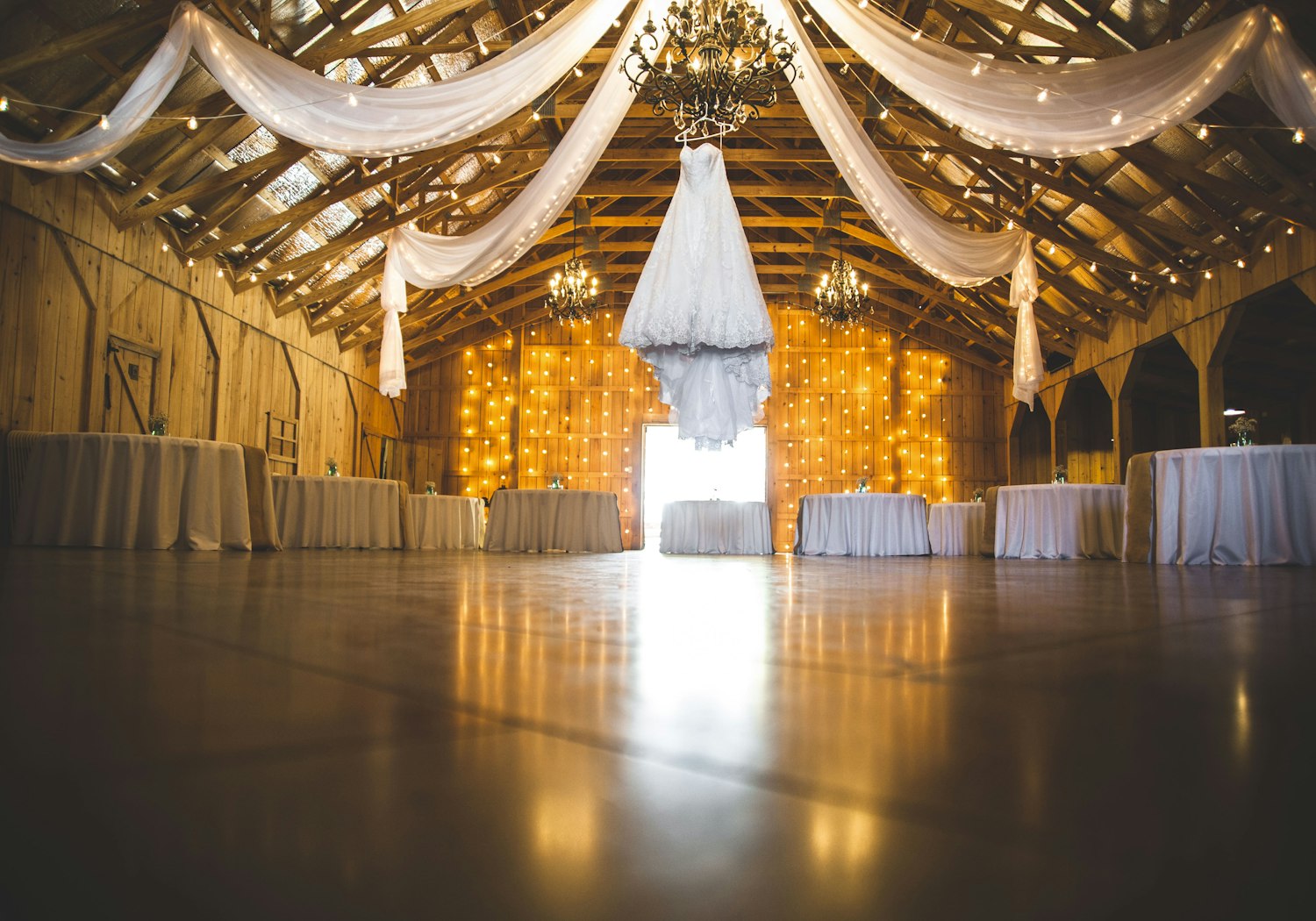 Warm string lights glowing over an evening wedding celebration