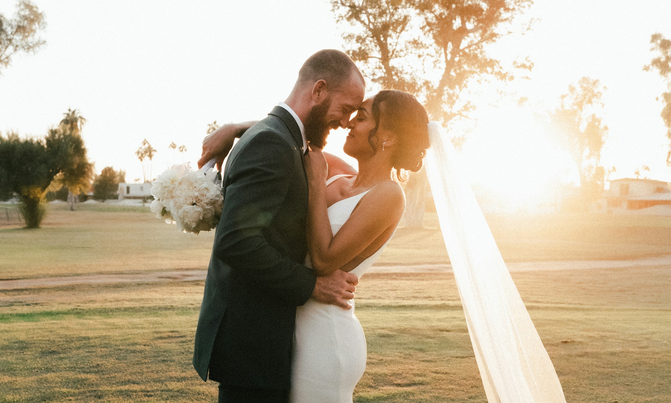 A couple sharing a quiet moment in golden evening light at their Texas wedding