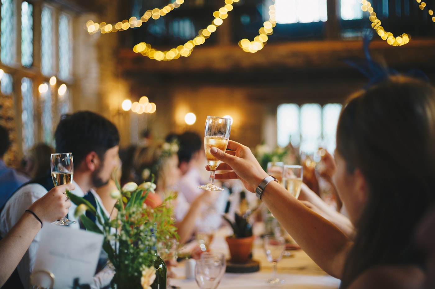A toast under warm string lights